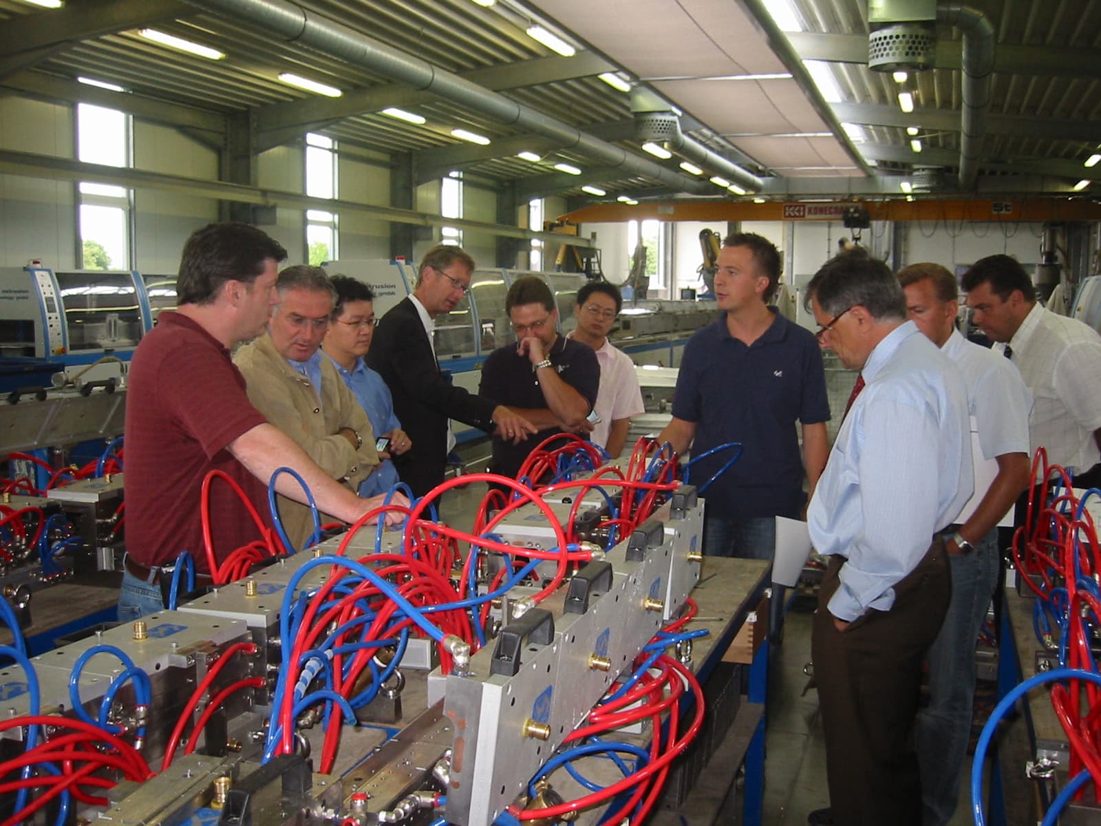 Barry Curtis reviewing plastics machinery with a team